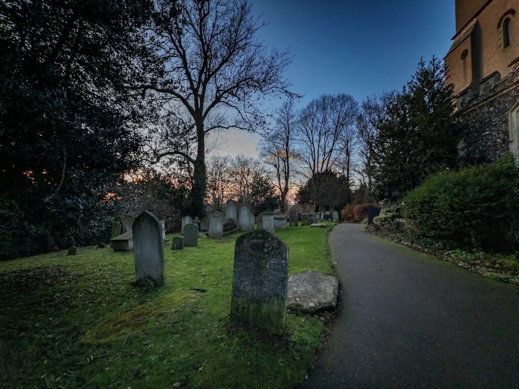 Graveyard path with gravestones at dusk