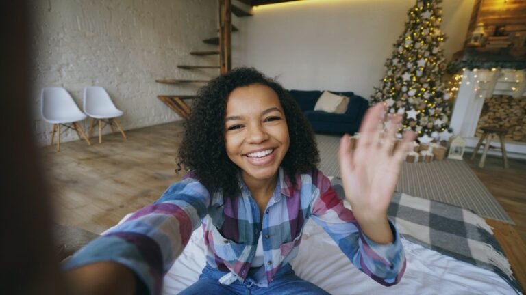 Young woman waving hello in a festive room