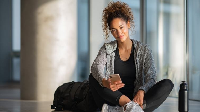 Confident independent woman casually checking phone while living her full busy life
