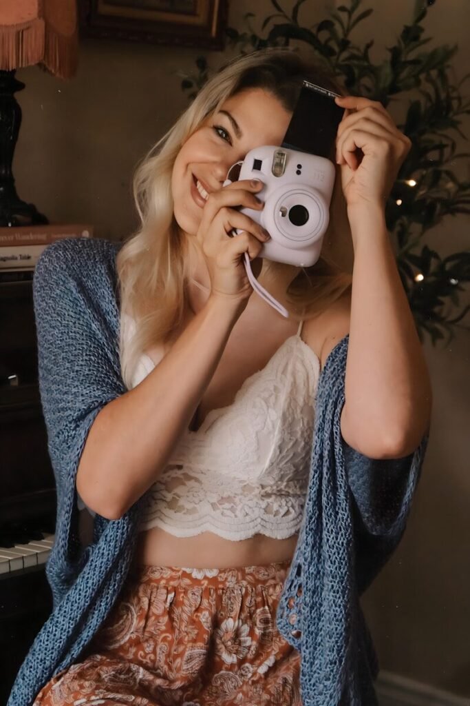 a woman taking a picture of herself with a camera