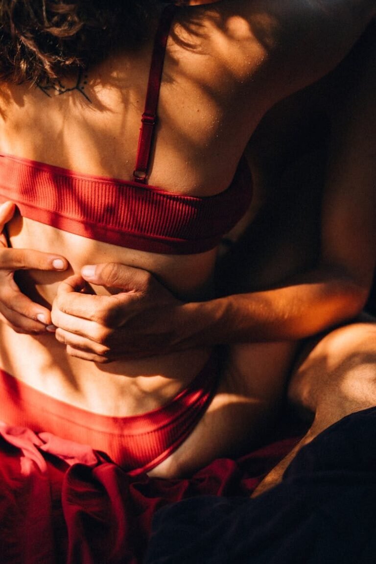 A couple embracing warmly, highlighting intimacy and connection in soft lighting.