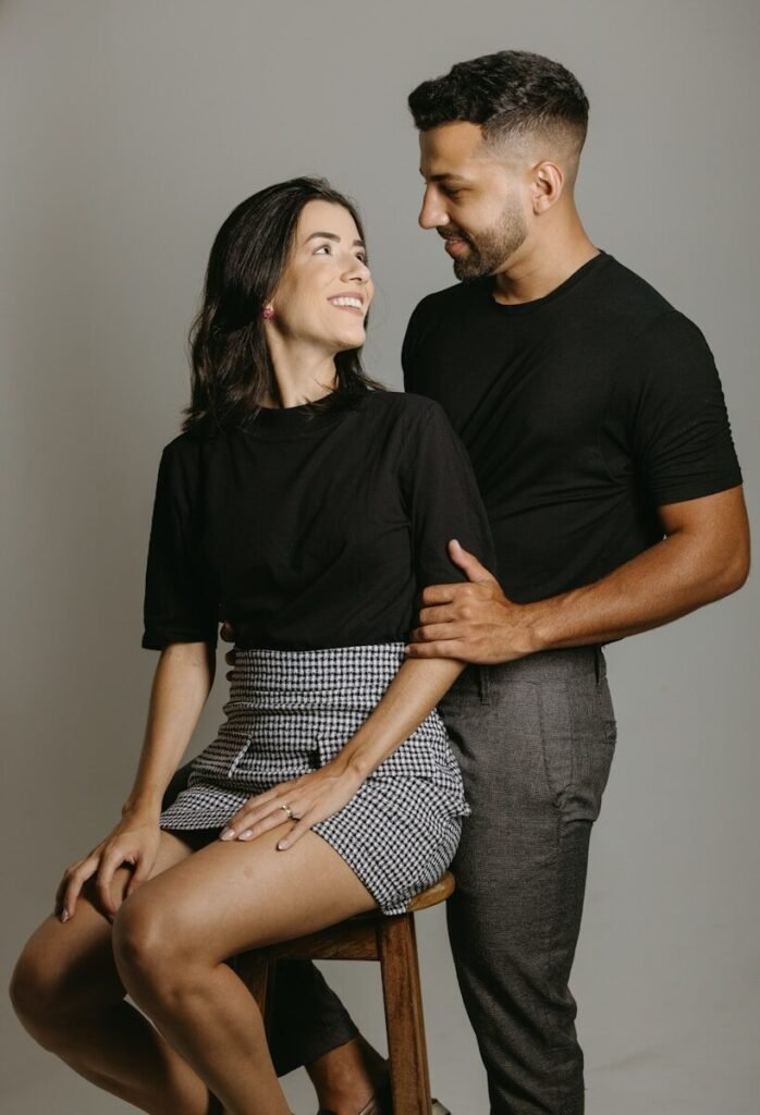a man and a woman sitting on a stool