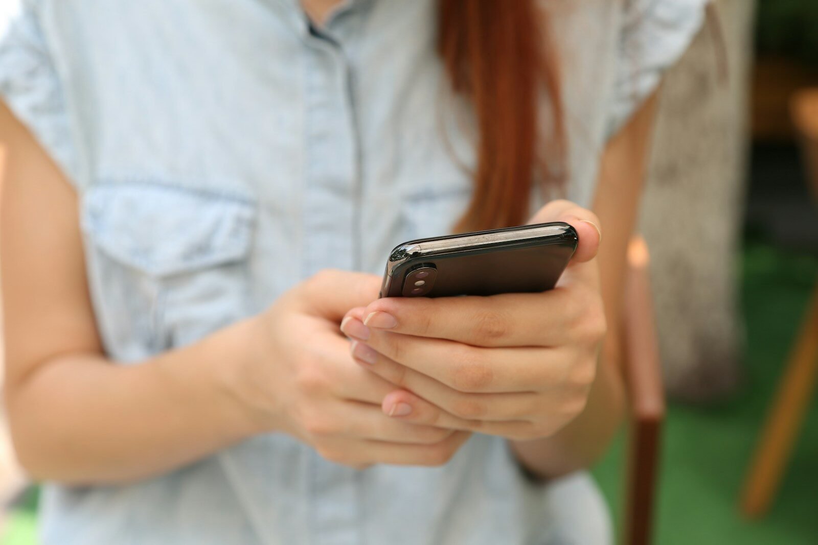 person holding using iPhone X