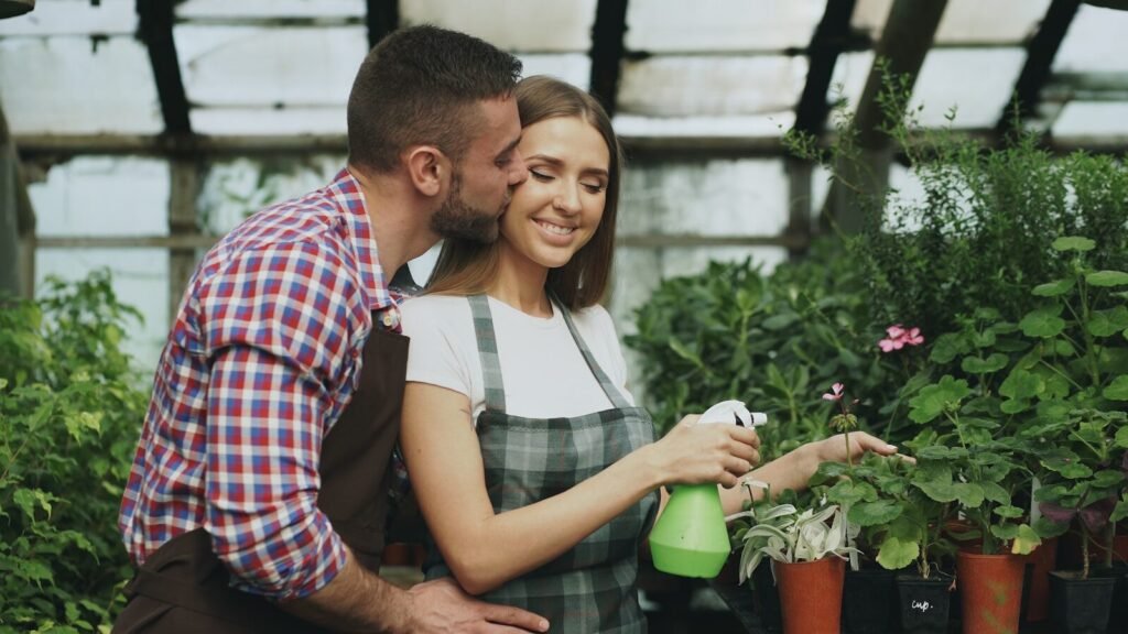 Couple tending plants in a greenhouse