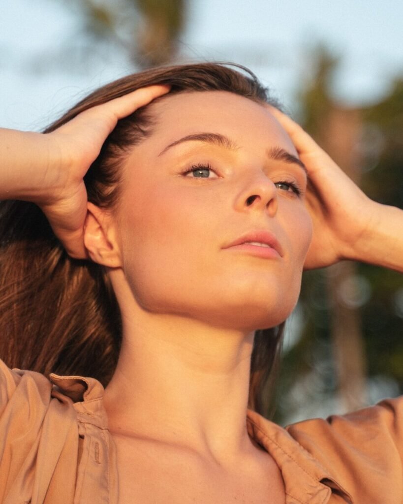 a woman with her hand on her head