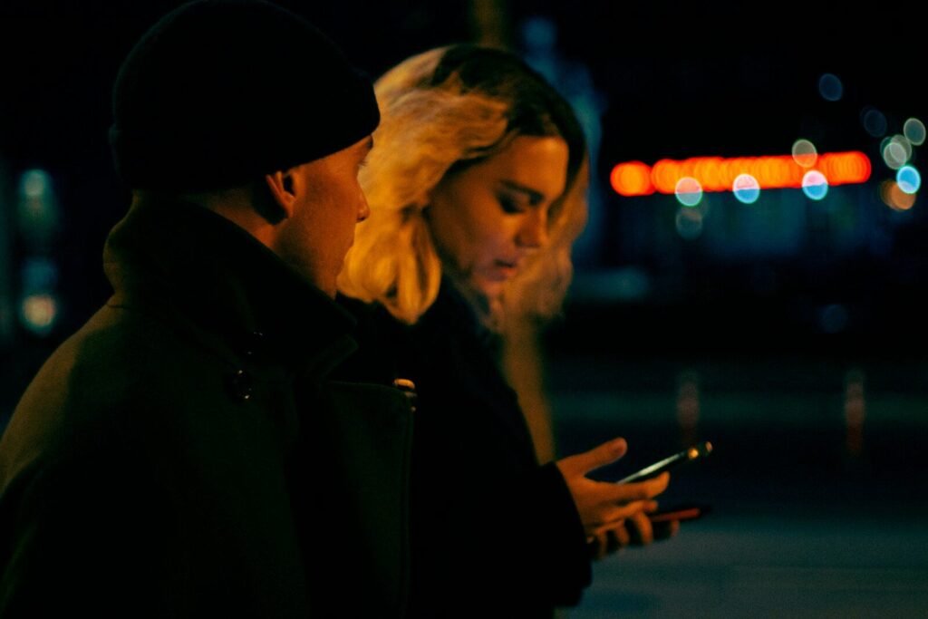 a man and woman looking at a cell phone