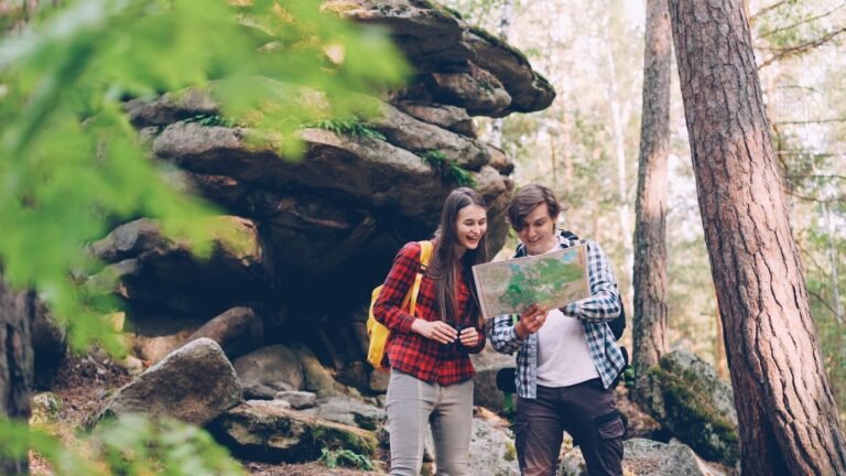 Couple looking at map in a forest