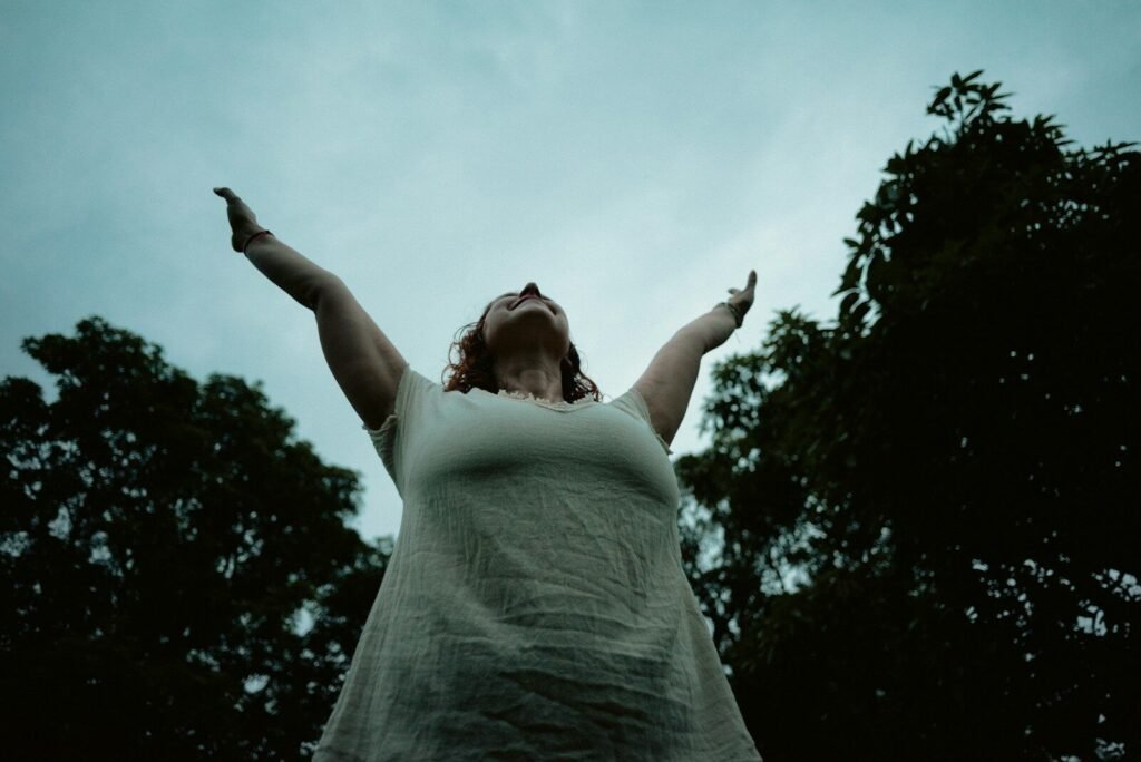 a woman with her arms outstretched in the air